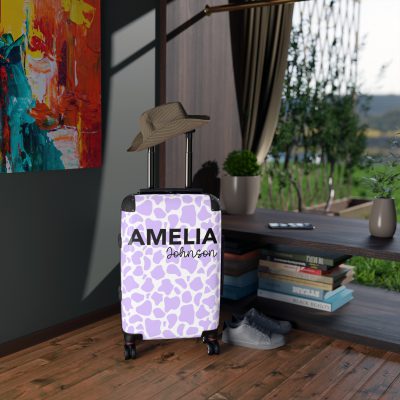 Custom Cow Print Suitcase - A personalized luggage adorned with a unique cow print design, perfect for travelers who want to add a touch of individuality to their journeys.