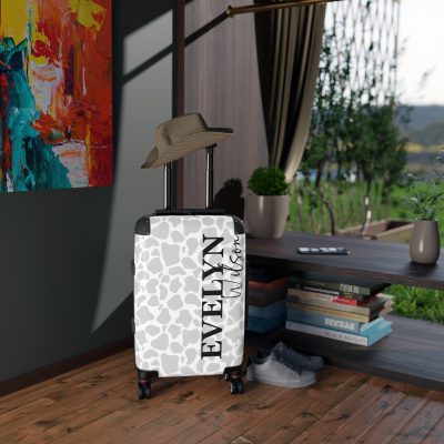 Custom Cow Print Suitcase - A personalized luggage adorned with a unique cow print design, perfect for travelers who want to add a touch of individuality to their journeys.