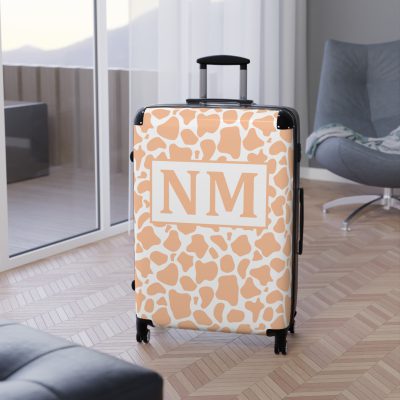 Custom Cow Print Suitcase - A personalized luggage adorned with a unique cow print design, perfect for travelers who want to add a touch of individuality to their journeys.