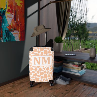 Custom Cow Print Suitcase - A personalized luggage adorned with a unique cow print design, perfect for travelers who want to add a touch of individuality to their journeys.