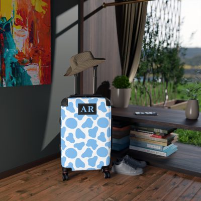 Custom Cow Print Suitcase - A personalized luggage adorned with a unique cow print design, perfect for travelers who want to add a touch of individuality to their journeys.