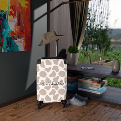 Custom Cow Print Suitcase - A personalized luggage adorned with a unique cow print design, perfect for travelers who want to add a touch of individuality to their journeys.